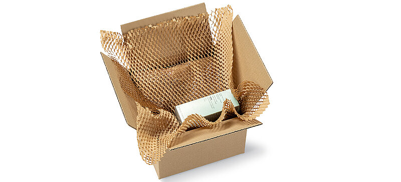 A box containing a product wrapped in brown paper padding.